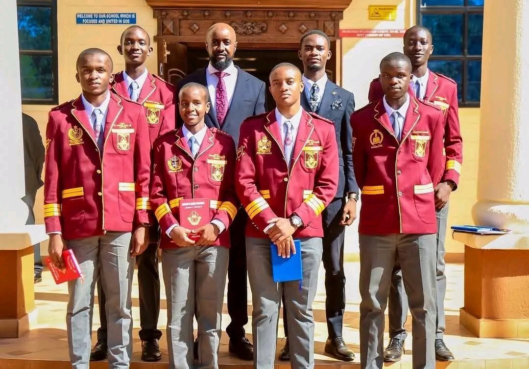 Mang'u High School student leaders in maroon blazers on the administration block steps